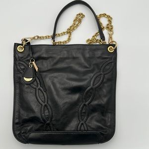 Black leather with gold chain. Cross body strap with chain link and leather.